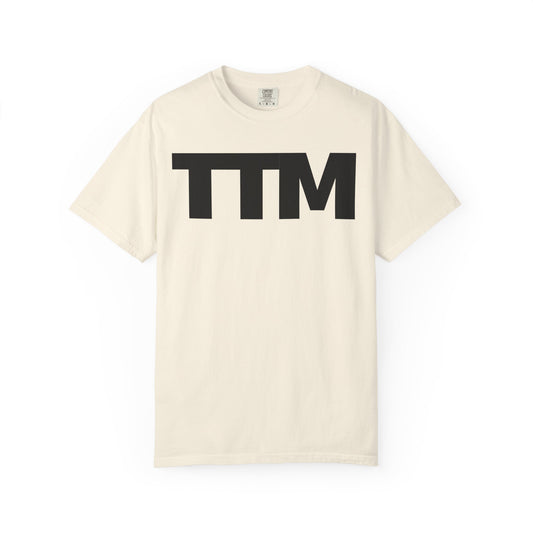 Beige t-shirt with 'TTM' printed in black on a white background
